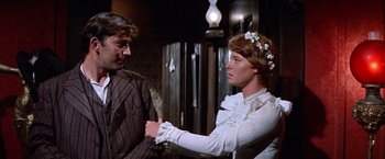 Movie still from “Ride the High Country” (1962), directed by Sam Peckinpah – A man and a woman standing next to each other in a room; Medium shot, Over the shoulder angle