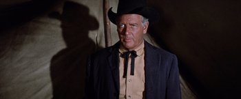 Movie still from “Ride the High Country” (1962), directed by Sam Peckinpah – An older man wearing a cowboy hat and a suit; Medium shot, Low angle
