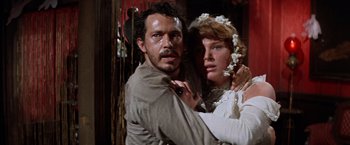 Movie still from “Ride the High Country” (1962), directed by Sam Peckinpah – A man and a woman embracing each other in a room; Close Up shot, Low angle