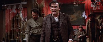 Movie still from “Ride the High Country” (1962), directed by Sam Peckinpah – A man in a brown suit and a man in a black suit; Medium shot, Low angle