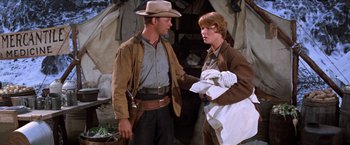 Movie still from “Ride the High Country” (1962), directed by Sam Peckinpah – A man in a cowboy hat talking to another man in a cowboy outfit; Medium shot, Over the shoulder angle