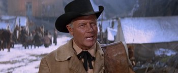 Movie still from “Ride the High Country” (1962), directed by Sam Peckinpah – An older man wearing a cowboy hat holding a wooden stick; Close Up shot, Low angle