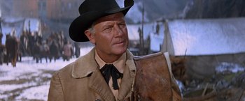 Movie still from “Ride the High Country” (1962), directed by Sam Peckinpah – An older man wearing a cowboy hat and holding an axe; Close Up shot, Low angle