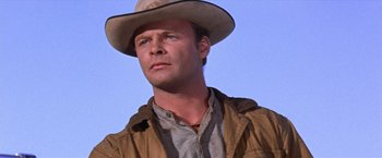 Movie still from “Ride the High Country” (1962), directed by Sam Peckinpah – A man wearing a cowboy hat and a brown jacket; Close Up shot, Low angle