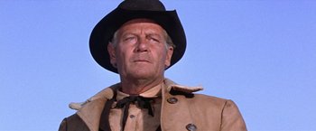 Movie still from “Ride the High Country” (1962), directed by Sam Peckinpah – An older man wearing a cowboy hat and a coat; Close Up shot, Low angle