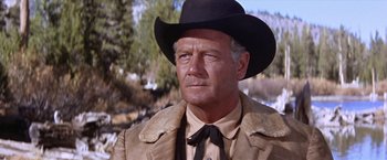 Movie still from “Ride the High Country” (1962), directed by Sam Peckinpah – An older man wearing a cowboy hat and a jacket; Close Up shot, Low angle