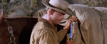 Movie still from “Ride the High Country” (1962), directed by Sam Peckinpah – A man in a cowboy hat holding a gun; Medium shot, Low angle