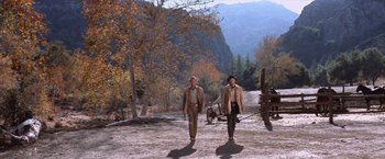 Movie still from “Ride the High Country” (1962), directed by Sam Peckinpah – A couple of men walking down a dirt road; Wide shot, Low angle