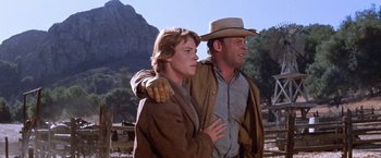 Movie still from “Ride the High Country” (1962), directed by Sam Peckinpah – A man and a woman standing next to each other; Medium shot, Low angle