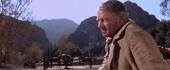 Movie still from “Ride the High Country” (1962), directed by Sam Peckinpah – An older man in a field with mountains in the background; Close Up shot, Low angle