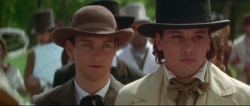 Movie still from “Ride with the Devil” (1999), directed by Ang Lee – Two men in hats and suits standing next to each other; Close Up shot, Low angle