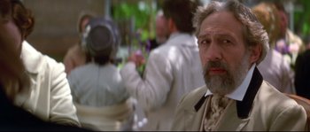 Movie still from “Ride with the Devil” (1999), directed by Ang Lee – An older man with a gray beard is looking into the camera; Close Up shot, Over the shoulder angle