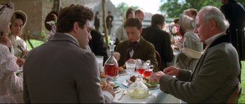 Movie still from “Ride with the Devil” (1999), directed by Ang Lee – A group of people sitting at a table with food; Medium shot, Over the shoulder angle