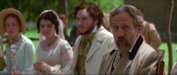 A group of people sitting next to each other in formal wear