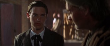 Movie still from “Ride with the Devil” (1999), directed by Ang Lee – A man in a suit and tie looking at another man in a suit and tie; Close Up shot, Over the shoulder angle