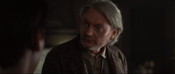 An older man with a gray beard looking at the camera