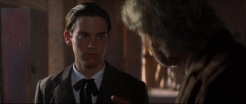 Movie still from “Ride with the Devil” (1999), directed by Ang Lee – A man in a suit and tie talking to another man in a suit and tie; Close Up shot, Over the shoulder angle