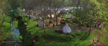 Movie still from “Ride with the Devil” (1999), directed by Ang Lee – An aerial view of people in a field with tents; Extreme Wide shot, High angle