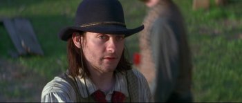 Movie still from “Ride with the Devil” (1999), directed by Ang Lee – A man in a hat and a tie; Close Up shot, Over the shoulder angle