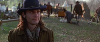 Movie still from “Ride with the Devil” (1999), directed by Ang Lee – A man wearing a blue hat and a brown jacket; Close Up shot, Over the shoulder angle