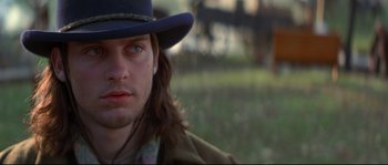 Movie still from “Ride with the Devil” (1999), directed by Ang Lee – A person wearing a hat; Close Up shot, Over the shoulder angle