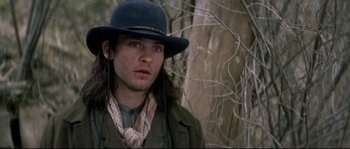 Movie still from “Ride with the Devil” (1999), directed by Ang Lee – A man wearing a blue hat and a green jacket; Close Up shot, Low angle