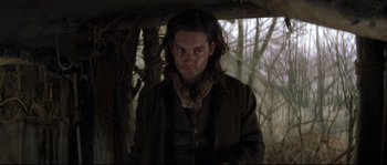 Movie still from “Ride with the Devil” (1999), directed by Ang Lee – A man with long brown hair wearing a brown jacket; Medium shot, Over the shoulder angle