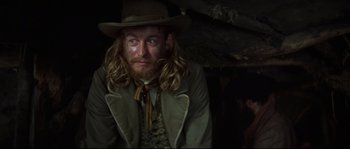 Movie still from “Ride with the Devil” (1999), directed by Ang Lee – A person with long hair and a cowboy hat; Close Up shot, Low angle