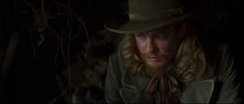 Movie still from “Ride with the Devil” (1999), directed by Ang Lee – A man with a beard wearing a hat and a coat; Close Up shot, Low angle