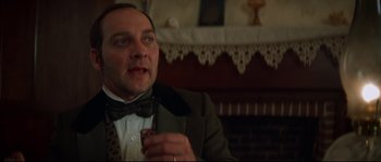 Movie still from “Ride with the Devil” (1999), directed by Ang Lee – A person wearing a suit and bow tie; Close Up shot, Over the shoulder angle