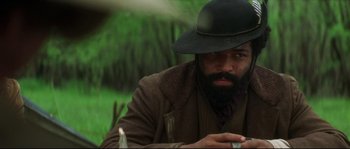 Movie still from “Ride with the Devil” (1999), directed by Ang Lee – A man with a beard wearing a black hat; Close Up shot, Over the shoulder angle