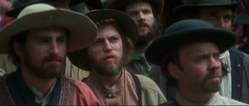 Movie still from “Ride with the Devil” (1999), directed by Ang Lee – A group of men wearing hats and a beard; Close Up shot, Over the shoulder angle