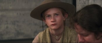 Movie still from “Ride with the Devil” (1999), directed by Ang Lee – A young boy wearing a cowboy hat and a vest; Close Up shot, High angle