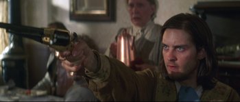 Movie still from “Ride with the Devil” (1999), directed by Ang Lee – A woman holding a gun in front of another woman; Close Up shot, Over the shoulder angle