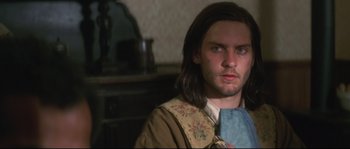 Movie still from “Ride with the Devil” (1999), directed by Ang Lee – A man with long brown hair wearing a brown jacket; Close Up shot, Over the shoulder angle