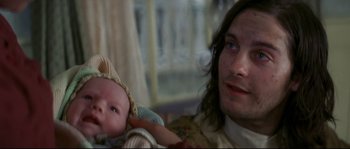 Movie still from “Ride with the Devil” (1999), directed by Ang Lee – A man holding a baby in his arms; Close Up shot, Over the shoulder angle