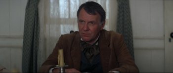 Movie still from “Ride with the Devil” (1999), directed by Ang Lee – An older man sitting at a table with a candle; Close Up shot, Over the shoulder angle