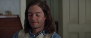 Movie still from “Ride with the Devil” (1999), directed by Ang Lee – A man with long brown hair and eyes closed; Close Up shot, Low angle