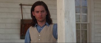 Movie still from “Ride with the Devil” (1999), directed by Ang Lee – A man with long brown hair wearing a vest; Close Up shot, Low angle