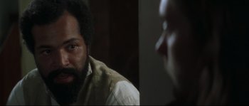 Movie still from “Ride with the Devil” (1999), directed by Ang Lee – A man sitting in front of another man in front of a mirror; Close Up shot, Over the shoulder angle