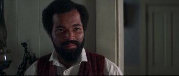 Movie still from “Ride with the Devil” (1999), directed by Ang Lee – A person with a beard wearing a vest; Close Up shot, Over the shoulder angle