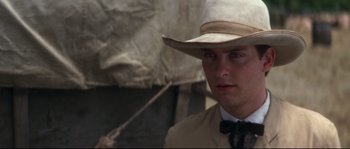 Movie still from “Ride with the Devil” (1999), directed by Ang Lee – A man wearing a cowboy hat and a suit; Close Up shot, Over the shoulder angle