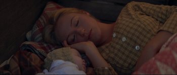 Movie still from “Ride with the Devil” (1999), directed by Ang Lee – A woman is sleeping with a baby in her arms; Close Up shot, Overhead angle
