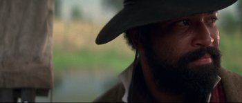 Movie still from “Ride with the Devil” (1999), directed by Ang Lee – A person wearing a hat; Close Up shot, Over the shoulder angle