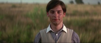 Movie still from “Ride with the Devil” (1999), directed by Ang Lee – A young man in a vest standing in front of a field; Close Up shot, Low angle