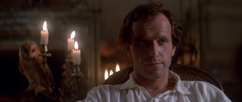 Movie still from “Ridicule” (1996), directed by Patrice Leconte – A person sitting in front of candles; Close Up shot, Over the shoulder angle