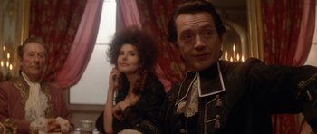 Movie still from “Ridicule” (1996), directed by Patrice Leconte – A man and a woman sitting next to each other; Close Up shot, Over the shoulder angle