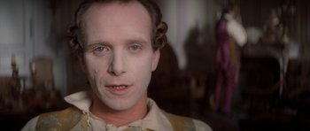 Movie still from “Ridicule” (1996), directed by Patrice Leconte – A person wearing makeup on their face; Close Up shot, Over the shoulder angle