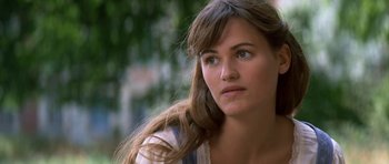 Movie still from “Ridicule” (1996), directed by Patrice Leconte – A person with long brown hair; Close Up shot, High angle