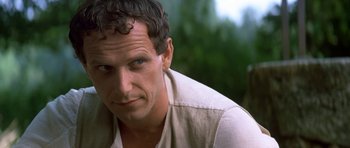 Movie still from “Ridicule” (1996), directed by Patrice Leconte – A person wearing a white shirt; Close Up shot, Over the shoulder angle
